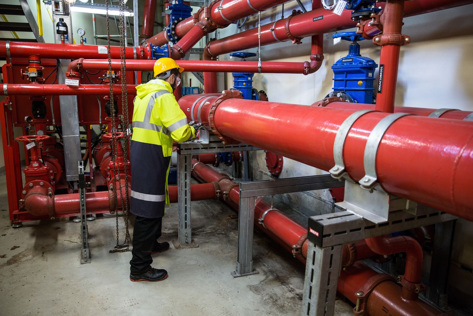 Engineer inspecting an industrial water piping system